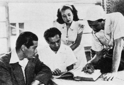 25_Toshiro Mifune Masayuki Mori Machiko Kyo and Akira Kurosawa on the set of The Idiot (1951).jpg