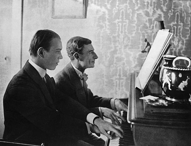 Choreographer Vaslav Nijinsky and composer Maurice Ravel at the piano playing a score from Daphnis and Chloe..jpg