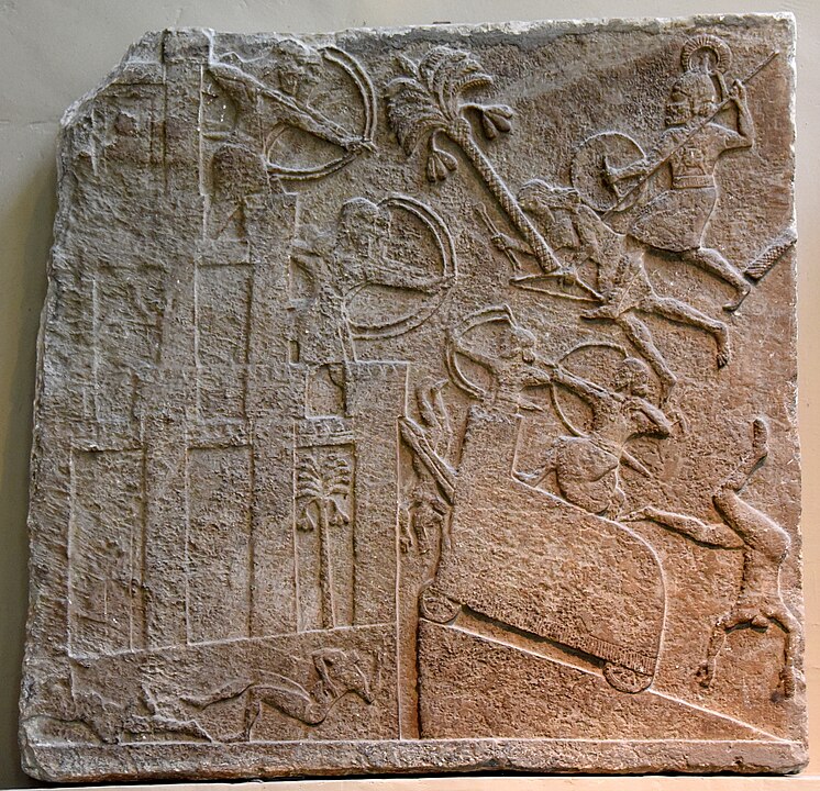 746px-Tiglath-pileser_III's_army_attacks_a_city_in_southern_Iraq._From_Nimrud,_Iraq,_c._728_BCE,_British_Museum.jpg